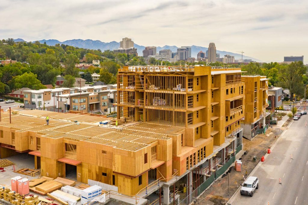 large multi level apartment building under construction with exposed wood framing